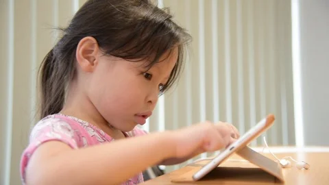 Girl playing games on tablet computer Stock Footage 95505385