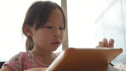 Girl playing games on tablet computer Stock Footage 95505484