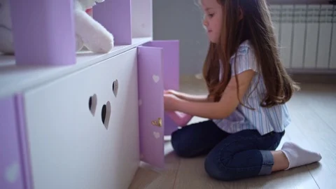 Girl Playing With A Giant Dollhouse In Her Room Stock Footage