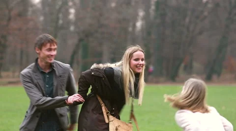 Girl playing with her parents in park Stock Footage 59554520