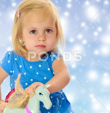 Girl playing with horse Stock Photos