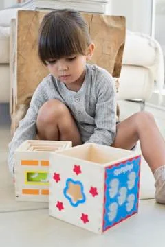 Girl playing with nested cubes Stock Photos