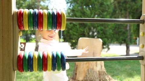 Girl playing on the playground with abacus Stock Footage 52433461