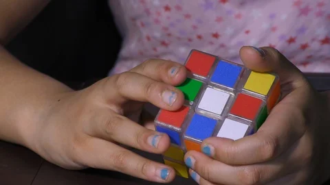 A girl playing with rubik cube Video stock 128199609