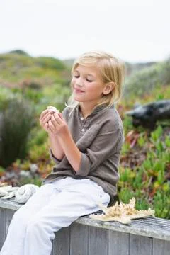 Girl playing with shells Stock Photos