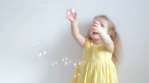 Girl playing with soap bubbles Stock Footage 61816144