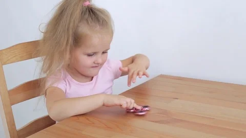 Girl playing with spinner Stock Footage 77213761