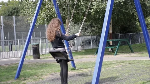 Girl playing on swing Stock Footage 101688826