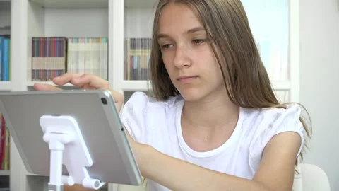 Girl Playing Tablet Browsing Internet, Kid Learning on Touchscreen Device, Stock Footage 333549267