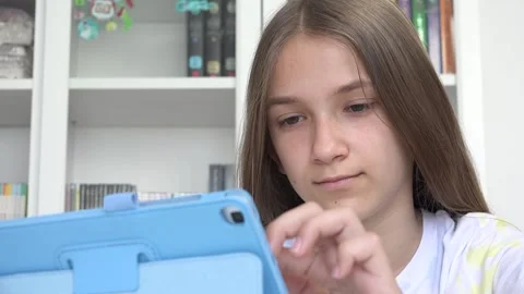 Girl Playing Tablet Browsing Internet, Child Learning on Touchscreen Device Stock Footage 334321907