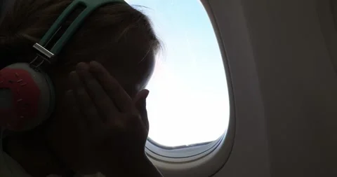 Girl playing on tablet during airplane flight Video stock 319872553