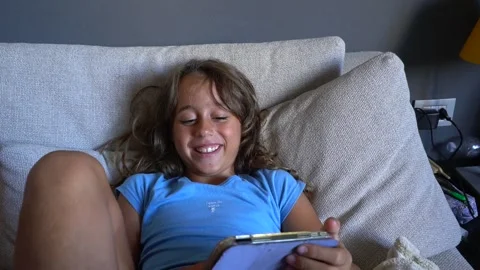 Girl playing with tablet Stock Footage 254064762