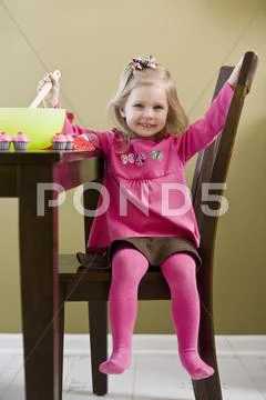 A girl playing with toy food and cooking utensils Stock Photos