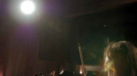 Girl playing violin in spotlight Stock Footage 44385367