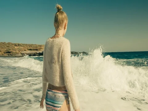 Girl playing in the waves at the beach Stock Footage 72946399