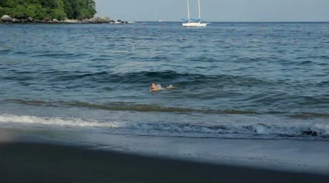 Girl Playing in the waves Video stock 23853383