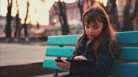 Girl is Playing within the Tablet Stock Footage 48459247