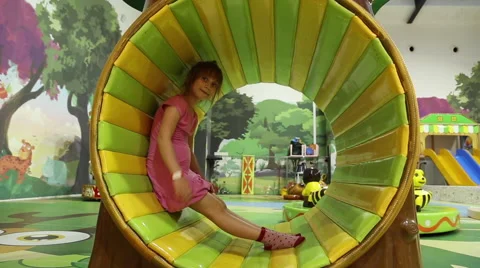 Girl plays on an attraction Stock Footage 64545365