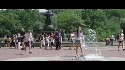 Girl Plays with Bubbles in Park while Boy runs by slow Stock Footage 57049612