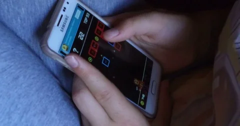 Girl plays with a cellphone Video stock 77912434