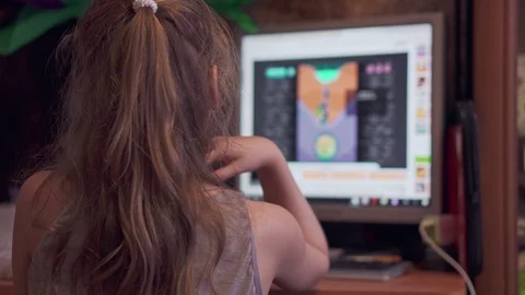 Girl plays a computer game on a computer Stock Footage 106957272