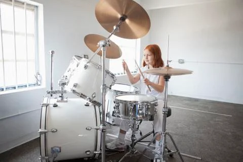 Girl plays drum kit Stock Photos