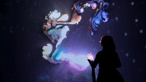 Girl plays with interactive video installation, hands draw letters word LOVE. Stock Footage 122456589