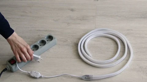Girl plug in socket Surge Protector and turn on the light. Concept new idea Stock Footage 128228493