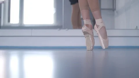 Girl in pointe doing a warm-up at the ballet choreographic machine  Video stock 106539705