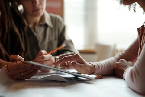Girl pointing at data on tablet screen Stock Photos