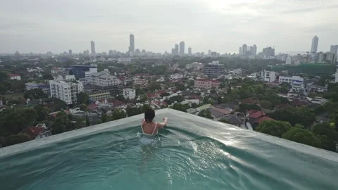 Girl in the pool background of the city Stock Footage 222049074