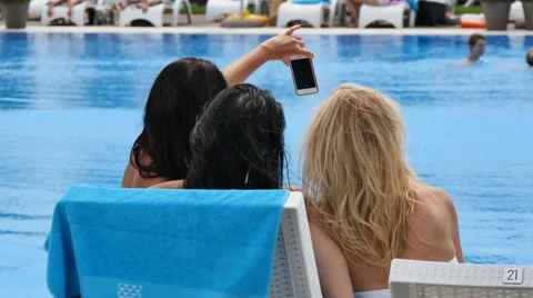 Girl in pool doing selfi Stock Footage 53772068