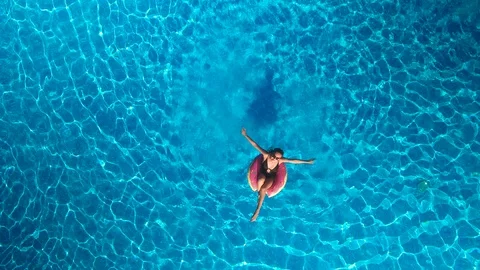 Girl in the pool with an inflatable circle Stock Footage 97695736