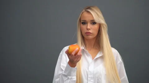 A girl poses with apples in the studio Stock Footage 170667963