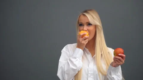 A girl poses with apples in the studio Stock Footage 170668500