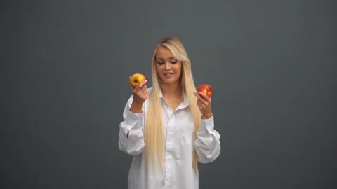 A girl poses with apples in the studio Stock Footage 170670154