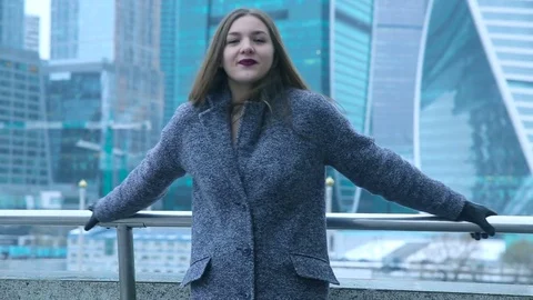 Girl posing against the backdrop of buildings Stock Footage 70148726