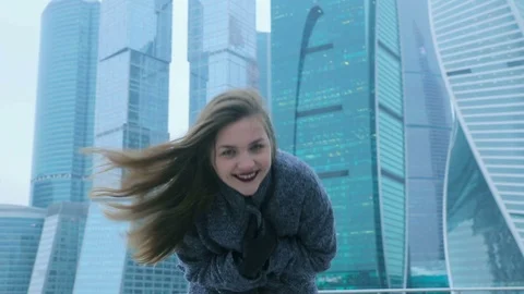 Girl posing against the backdrop of a skyscraper Stock Footage 70148949
