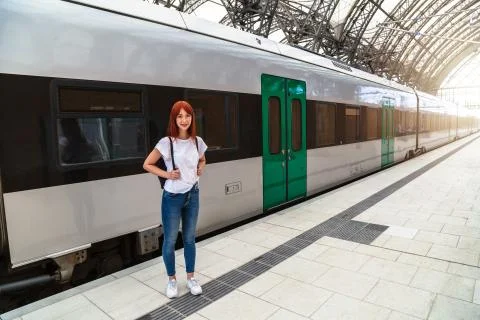 Girl posing on background of train on platform Stock Photos