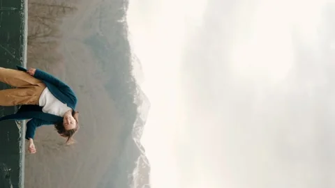 Girl posing on camera in blue coat in mountains 스톡 동영상 158694529