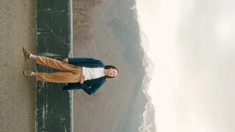 Girl posing on camera in blue coat in mountains Stock Footage 158694763