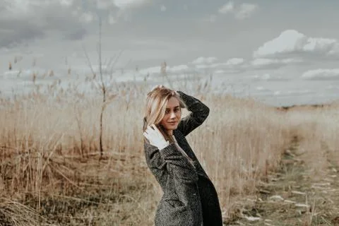 Girl posing at camera on bulrush background Stock Photos