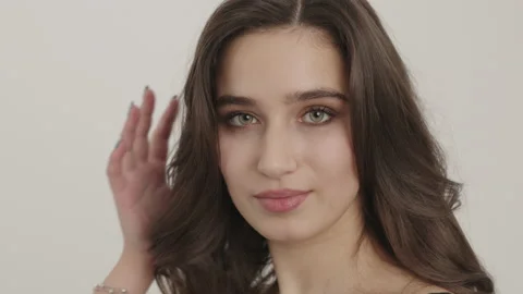 Girl posing for the camera. First closes the eyes then tears them away. Stock-Footage 156382613