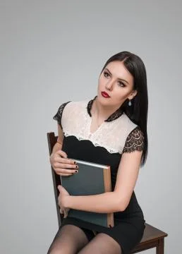 Girl posing on a chair Foto stock