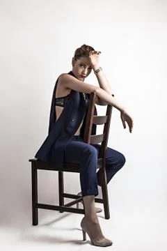 Girl posing on a chair in the studio Foto stock