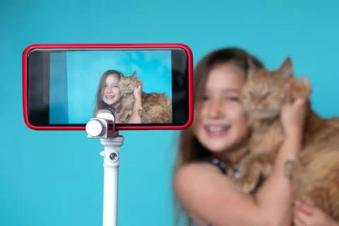 Girl posing in front of camera with cat 스톡 사진