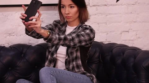 Girl posing in front of camera makes selfie Stock Footage 68910268