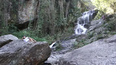 Girl posing in front of waterfall Stock Footage 43862468