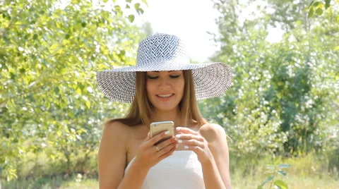Girl posing in a hat outdoors Stock Footage 66774103