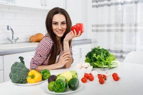 Girl Posing at a Kitchen Table With Bell Pepper Stock Photos